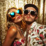 Atlanta friends posing with props, gold backdrop.