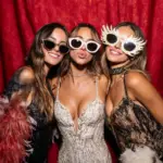 Gold themed Atlanta photo booth with friends posing in stylish outfits