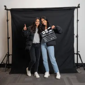 Guests posing with props in birthday photo booth in Atlanta